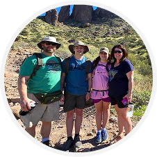 ellipse 2 Four people hiking in a desert landscape.